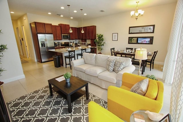 314 Captiva Dr, Davenport, FL 33896 - living room featuring light tile patterned flooring, a chandelier, recessed lighting, and baseboards
