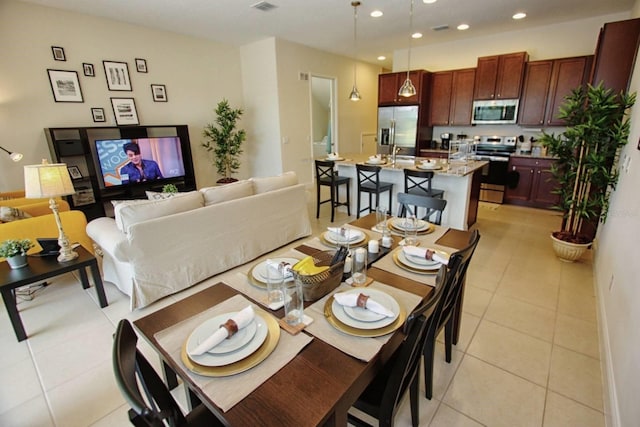 dining space featuring light tile patterned floors