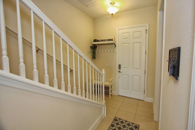 314 Captiva Dr, Davenport, FL 33896 - tiled foyer entrance with baseboards and stairs