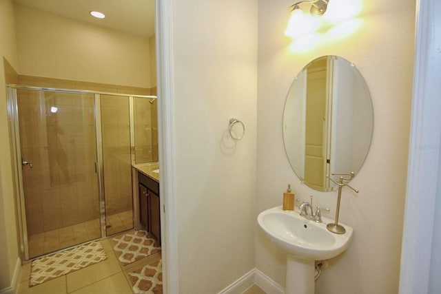 bathroom featuring sink, tile patterned floors, and a shower with shower door