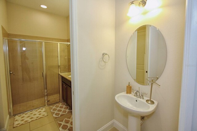 314 Captiva Dr, Davenport, FL 33896 - bathroom featuring a shower stall, tile patterned flooring, baseboards, and a sink