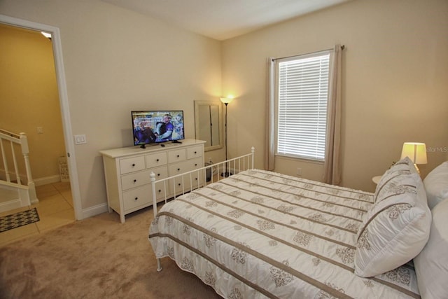 bedroom featuring light carpet