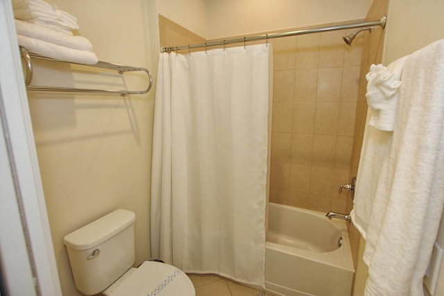 bathroom featuring tile patterned floors, shower / bath combination with curtain, and toilet