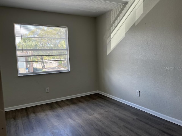 spare room featuring dark wood-type flooring