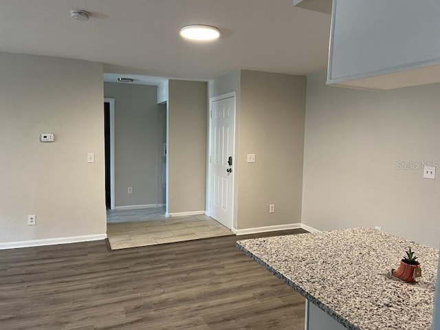 spare room featuring dark wood-type flooring