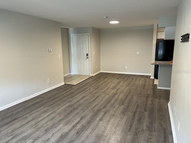 unfurnished living room with dark hardwood / wood-style flooring