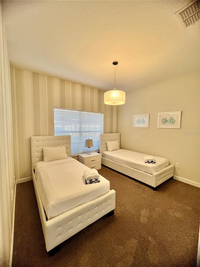 carpeted bedroom featuring a textured ceiling