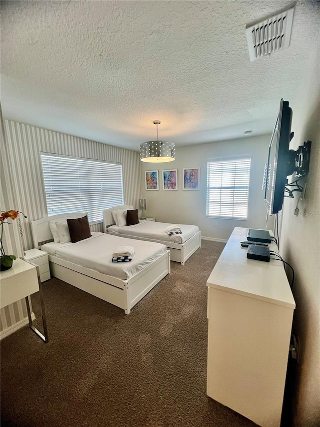 carpeted bedroom with a textured ceiling