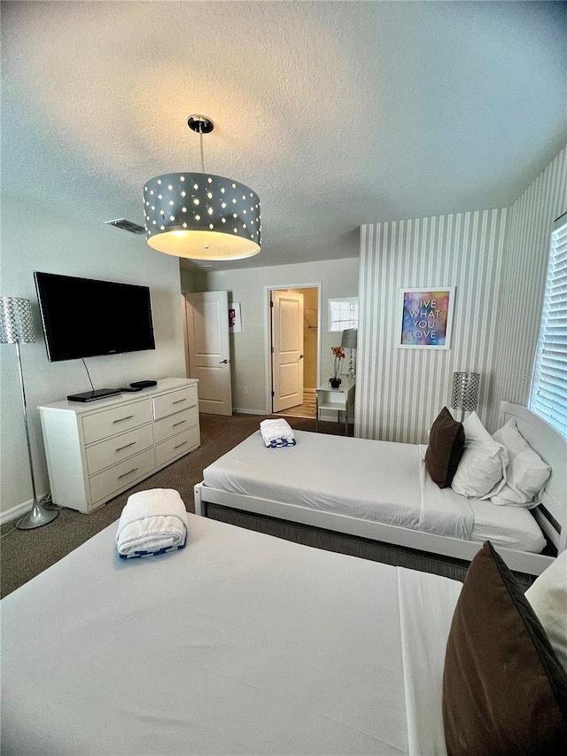 carpeted bedroom with a textured ceiling