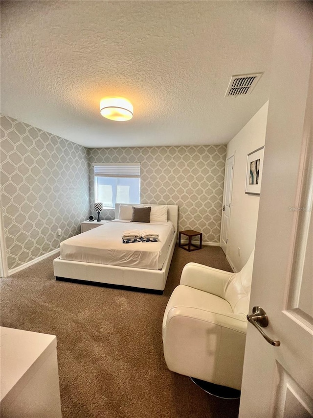 carpeted bedroom featuring a textured ceiling