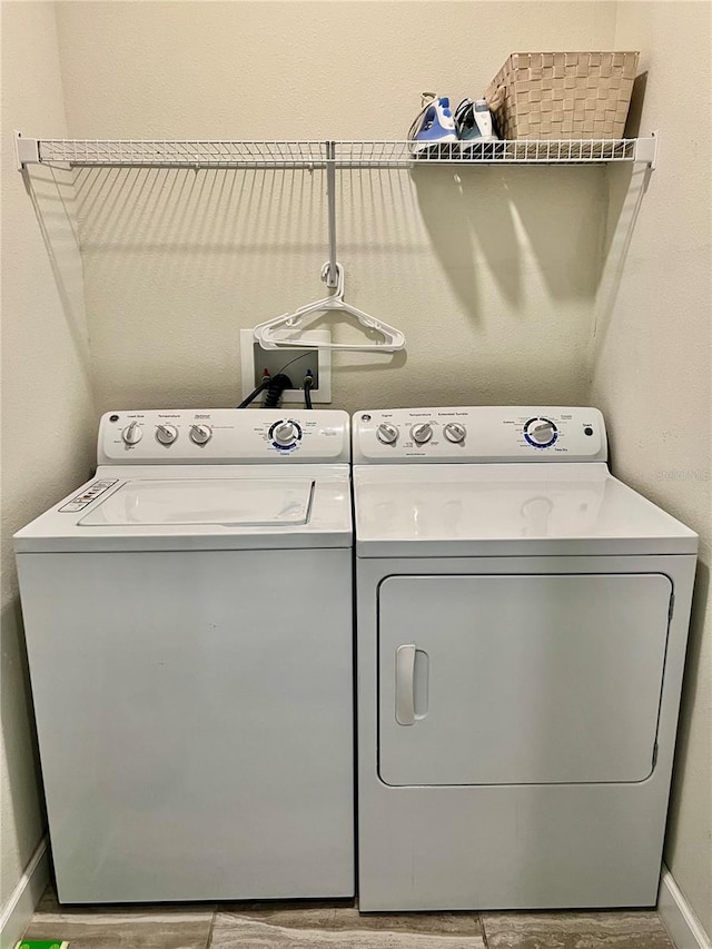 washroom with washer and dryer and hardwood / wood-style floors