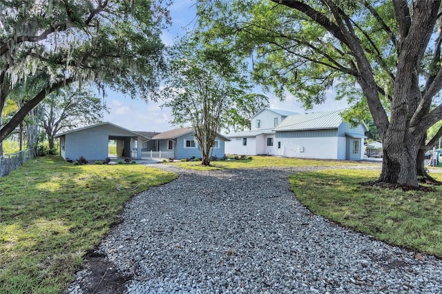 single story home with driveway, fence, and a front yard