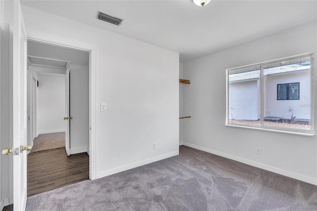 unfurnished bedroom featuring baseboards, visible vents, and carpet flooring