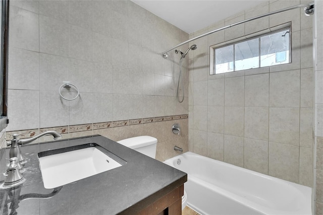 full bathroom with toilet, vanity, tile walls, and shower / bathing tub combination