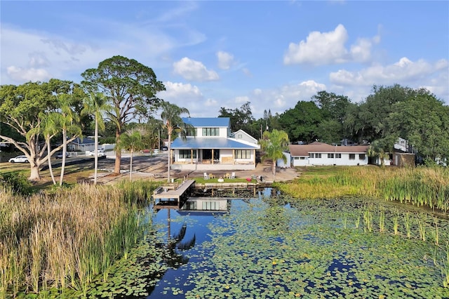 back of property with a water view