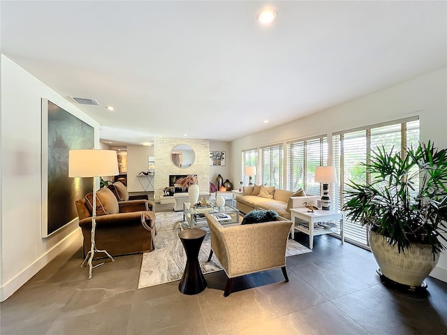 living room with a fireplace and plenty of natural light