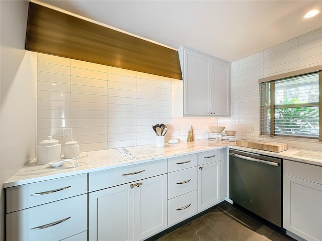 kitchen featuring light stone counters, white cabinets, dishwasher, and tasteful backsplash