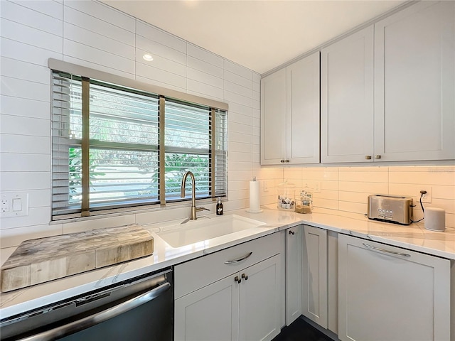 kitchen featuring white dishwasher, decorative backsplash, sink, and dishwasher