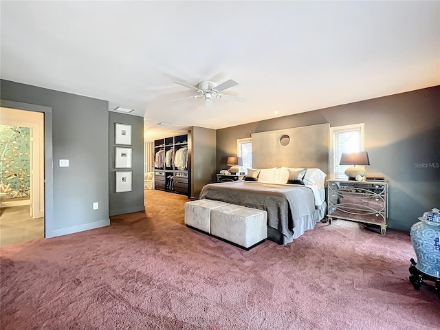 carpeted bedroom featuring ceiling fan and a closet