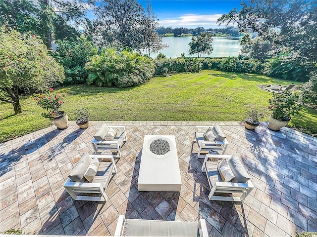 view of patio featuring a water view and an outdoor fire pit