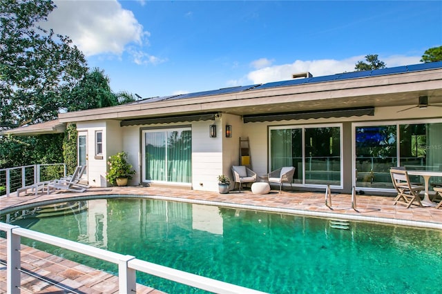 view of swimming pool with a patio and ceiling fan