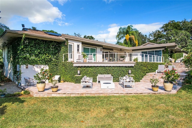 back of property with a yard and a patio area