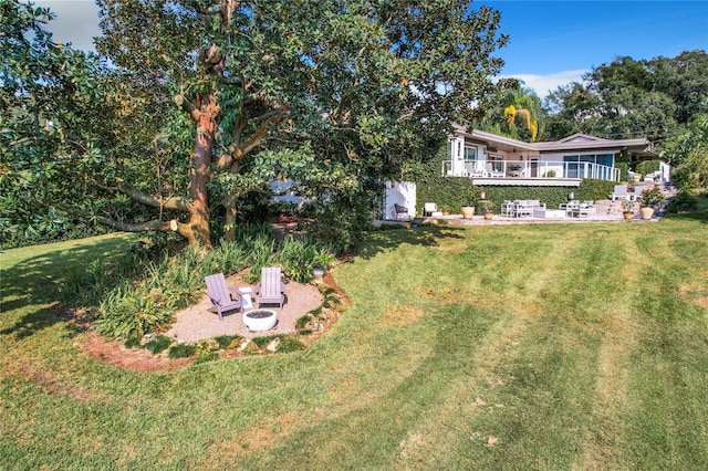 view of yard with an outdoor fire pit