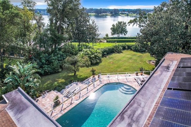 view of pool with a water view, a yard, and a patio area