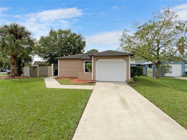 ranch-style house featuring a garage and a front lawn