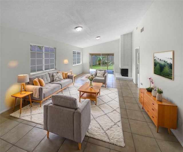 living room with tile patterned flooring, vaulted ceiling, and a textured ceiling