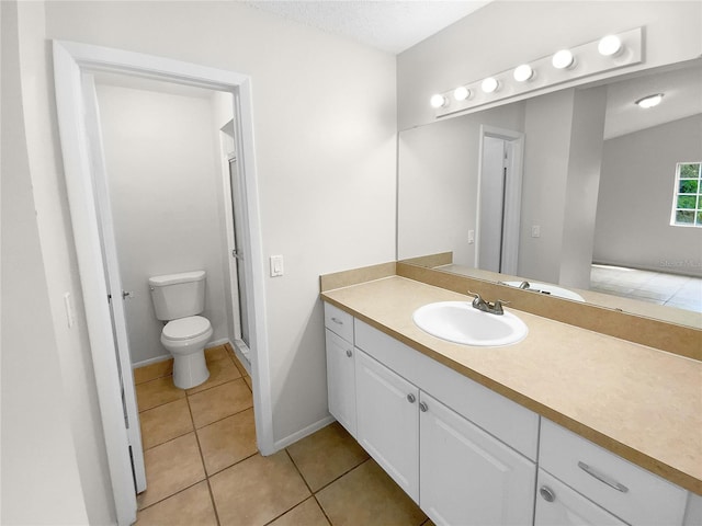 bathroom with tile patterned floors, vanity, and toilet