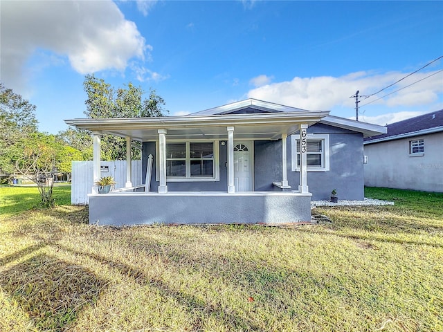 view of front of property with a porch and a front lawn