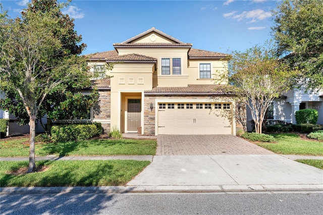 mediterranean / spanish-style home with a front lawn and a garage