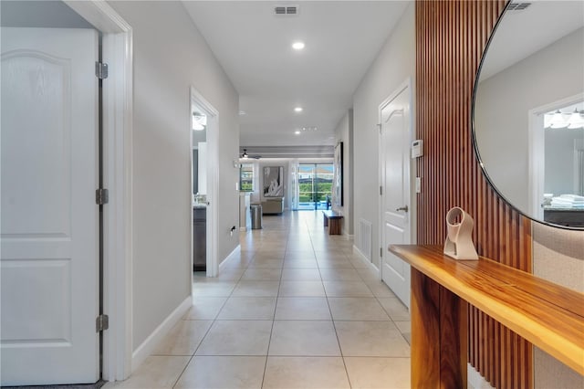 hall with light tile patterned floors