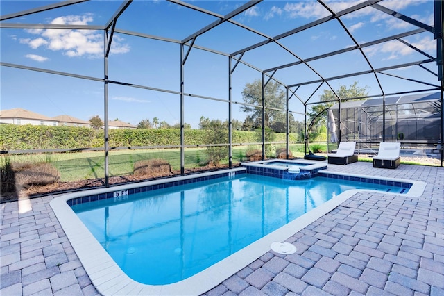 view of swimming pool featuring an in ground hot tub, a patio area, and glass enclosure