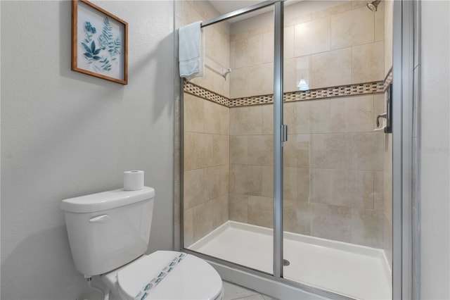 bathroom featuring toilet and an enclosed shower