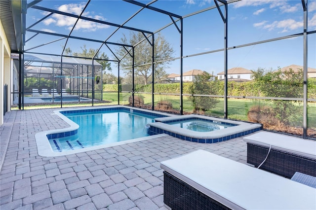 view of swimming pool featuring a patio, an in ground hot tub, and a lanai