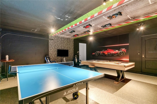 playroom featuring a textured ceiling and a fireplace