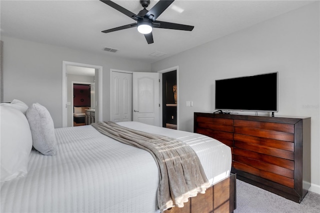 bedroom with light carpet, ensuite bathroom, and ceiling fan