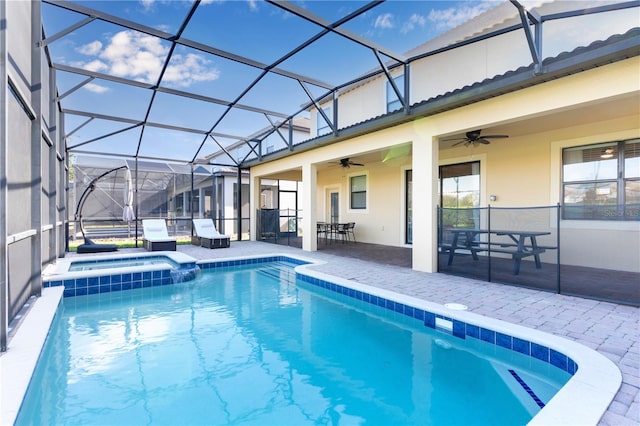 view of swimming pool with an in ground hot tub, ceiling fan, a patio area, and a lanai