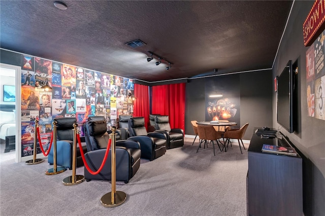 home theater with a textured ceiling, track lighting, and carpet floors