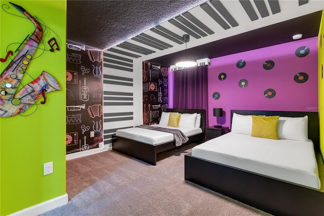 bedroom featuring a textured ceiling and carpet floors