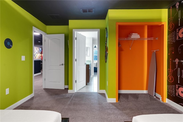 carpeted bedroom featuring a closet