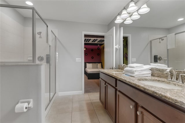 bathroom featuring vanity, tile patterned flooring, and a shower with door