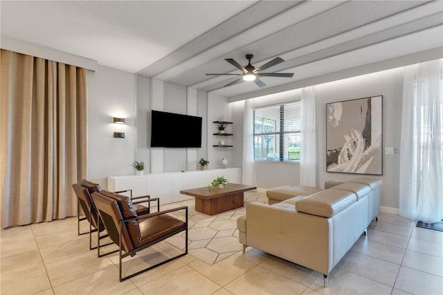 living room featuring beamed ceiling, ceiling fan, and light tile patterned floors