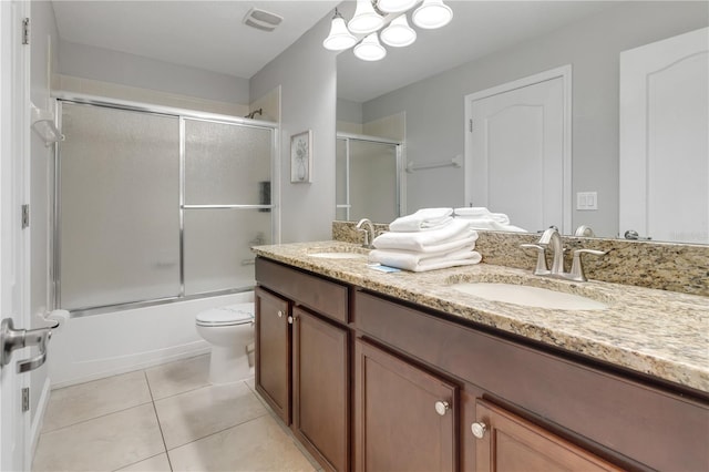 full bathroom with vanity, enclosed tub / shower combo, toilet, and tile patterned floors