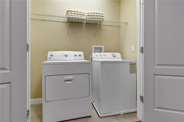 washroom with light tile patterned floors and separate washer and dryer