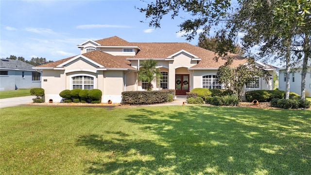 view of front of home featuring a front yard and french doors