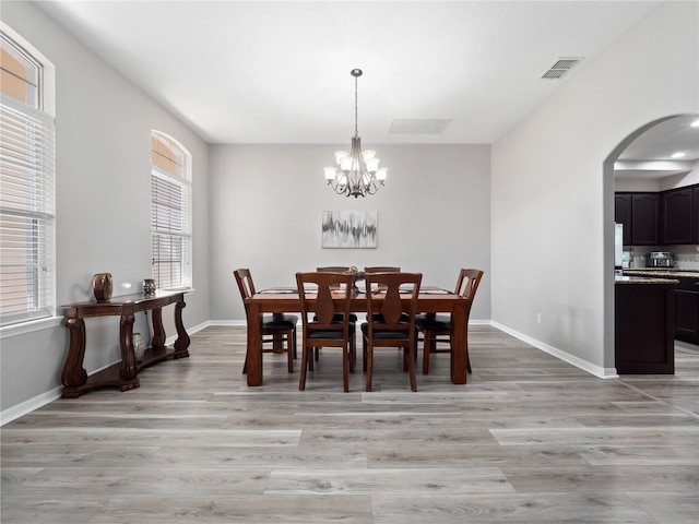 dining room featuring light hardwood / wood-style floors and a notable chandelier