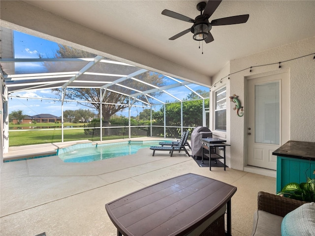 view of pool featuring ceiling fan, a lanai, and a patio area